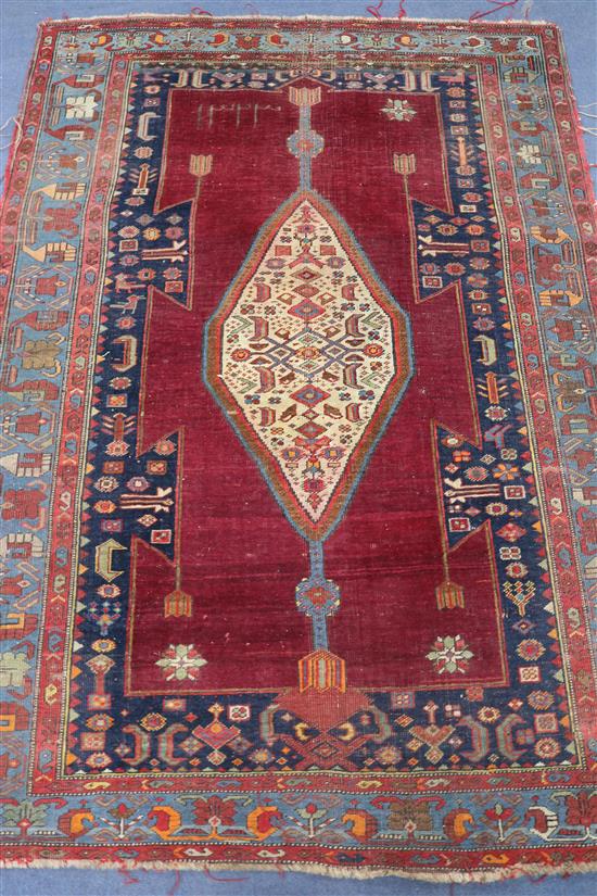 A Caucasian red and blue ground rug W.174cm x 120cm